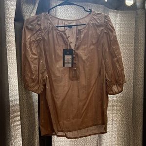 Tan blouse with white stitching